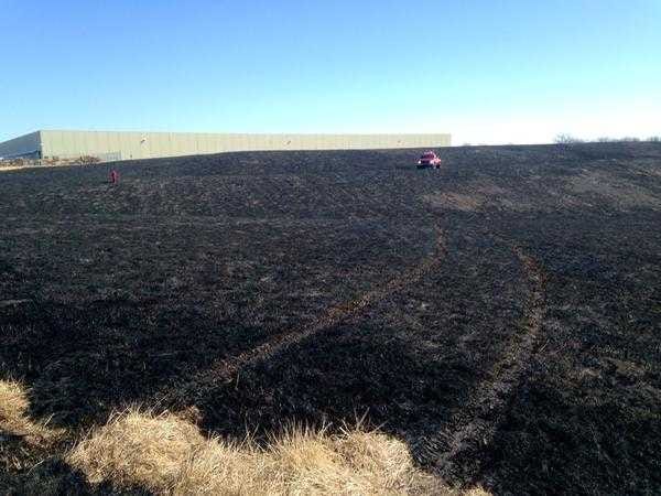 A fairly extensive, out-of-control grass fire caused by a spark from an arcing Westar Energy powerline got within an estimated 300 feet of the Target Distribution Center early on Tuesday afternoon in south Topeka before crews put the fire out.