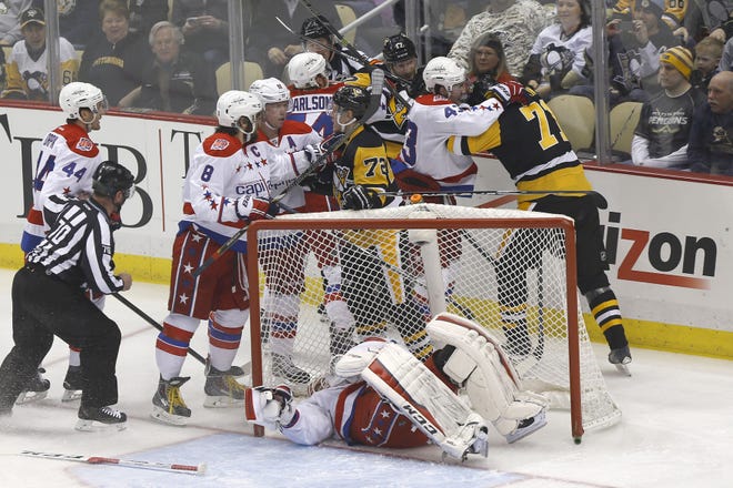 The Penguins and Capitals tangle behind goalie Braden Holtby (70) in the first period of their game in Pittsburgh on Tuesday, Feb. 17. While the Penguins say they won't seek revenge for Alex Ovechkin's slash of Kris Letang during the game, they say they will be out to avenge a three-game losing streak to their divisional rival.