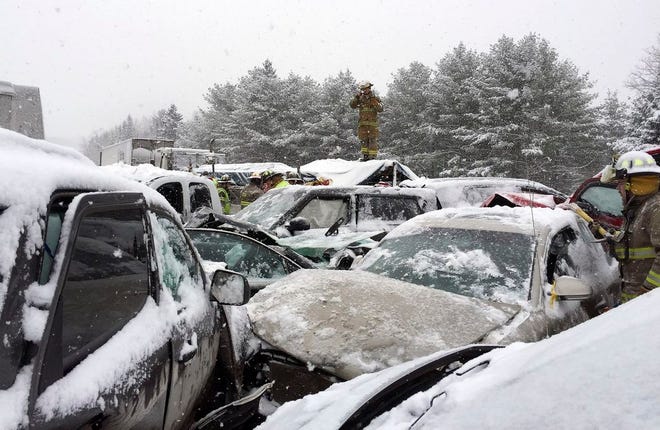 In this photo provided by Maine State Police and Maine Emergency Management, emergency personnel respond to a multi-vehicle pileup along Interstate 95 in Etna, Maine, about 20 miles west of Bangor, Wednesday, Feb. 25, 2015. State police spokesman Steve McCausland said the pileup happened early Wednesday in heavy snow and involved many cars, a school bus and a semitrailer. No fatalities were immediately reported but McCausland said some of the injuries were serious. (AP Photo/Maine State Police and Maine Emergency Management, Stephen McCausland)