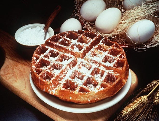 Waffles, dusted with powdered sugar, make a hearty breakfast for a cold winter morning.