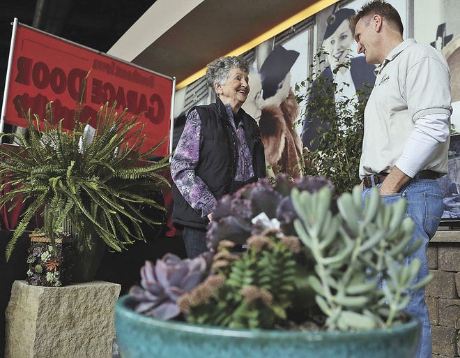John Lovretta/The Hawk Eye Irene Sheridan talks with Scott Zaiser of Zaiser's Landscaping Inc. during the 2014 Burlington Home Show at the Pzazz Convention and Event Center. The Home Show is this weekend at Pzazz Convention and Event Center.