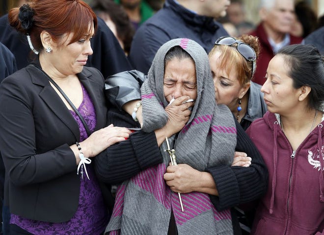 Agapita Montes-Rivera, second from left, the mother of Antonio Zambano-Montes, is comforted following the funeral for her son Wednesday, Feb. 25, 2015, at St. Patrick's Catholic Church in Pasco, Wash. Zambrano-Montes' Feb. 10 death in the agricultural city of Pasco has sparked protests and calls for a federal investigation. Police killed the unarmed man who spoke little English after he allegedly threw rocks at officers. (AP Photo/The Tri-City Herald, Andrew Jansen)