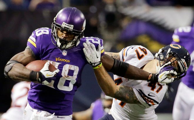 In this Dec. 1, 2013, fikle photo, Minnesota Vikings running back Adrian Peterson, left, tries to break a tackle from Chicago Bears free safety Chris Conte during the fourth quarter of an NFL football game in Minneapolis. A federal judge has cleared the way for Peterson to be reinstated. U.S. District Judge David Doty issued his order Thursday, Feb. 26, 2015, less than three weeks after hearing oral arguments.