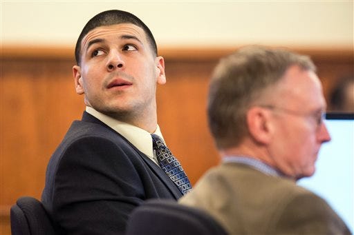 Former New England Patriots football player Aaron Hernandez, right, sits beside his attorney Charles Rankin, right, during his murder trial at Bristol County Superior Court in Fall River Wednesday.