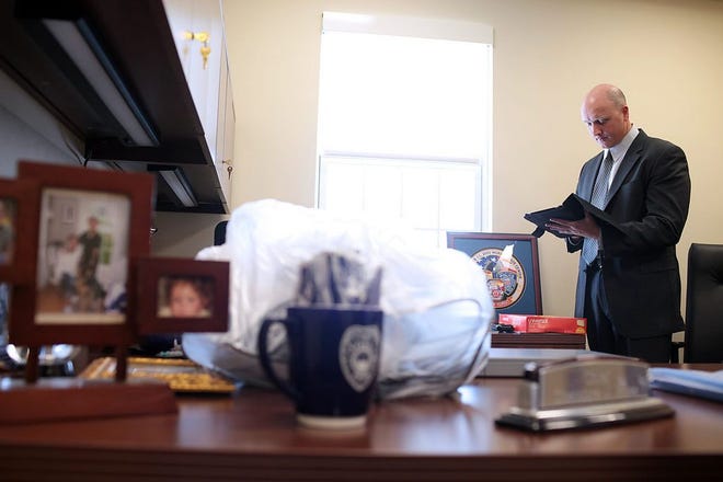 Norwell Police Chief Ted Ross checks his iPad in his office at the police department’s new station on Route 53.