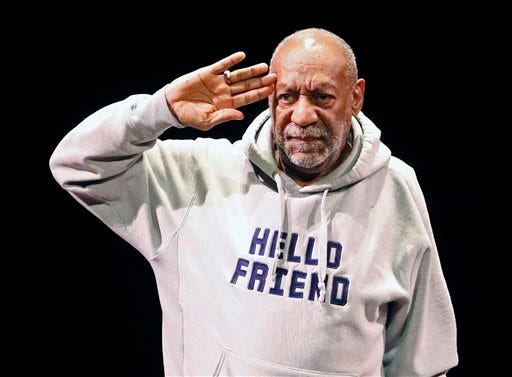 In this Jan. 17, 2015 file photo, comedian Bill Cosby salutes the crowd as he begins a performance at the Buell Theater in Denver. Cosby's lawyers asked a federal judge on Friday, Feb. 27, to throw out a defamation lawsuit filed by three women accusing the comedian of decades-old sexual offenses. The women, all of whom have stepped forward in recent years, say Cosby's representatives publicly branded them as liars while trying to defend Cosby's innocence. (AP Photo/Brennan Linsley, File)