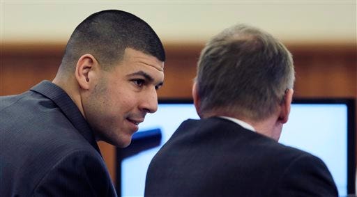 Former New England Patriots NFL football player Aaron Hernandez, left, talks with his lawyer Charles Rankin during his murder trial at Bristol County Superior Court in Fall River, Mass., Thursday, Feb. 26, 2015. Hernandez is charged in the murder of Odin Lloyd in 2013.