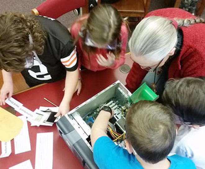 Students in the Barringer Road Tech Wolves technology club dissect a computer to learn how it works. SUBMITTED PHOTO