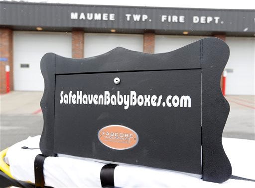 A prototype of a baby box, where parents could surrender their newborns anonymously, is shown outside the fire station in Woodburn, Ind., Thursday, Feb. 26, 2015. The box is actually a newborn incubator, or baby box, and it could be showing up soon at Indiana hospitals, fire stations, churches and other selected sites under legislation that would give mothers in crisis a way to surrender their children safely and anonymously.