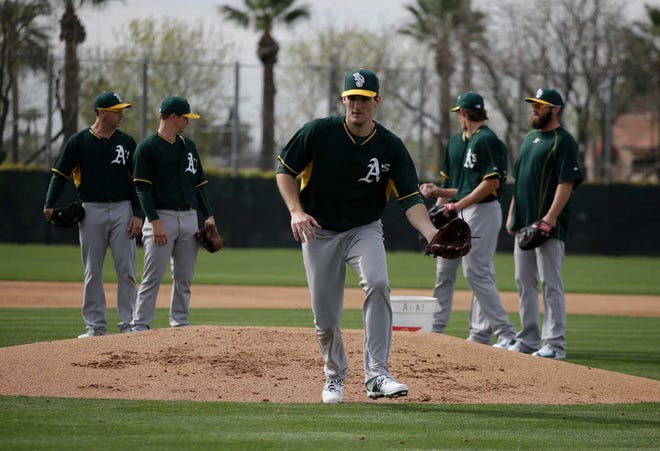 The Oakland Athletics' Dan Otero makes a play during spring training baseball practice on Friday, Feb. 20, in Mesa, Ariz.