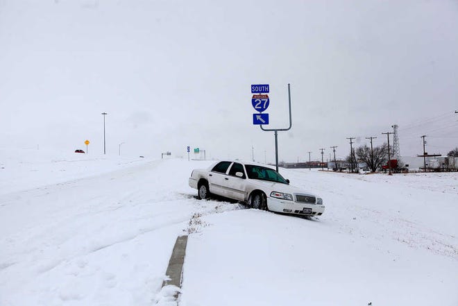 A car is stalled on the access road of Interstate 27 on Friday in Lubbock. The Hub City saw 4.1 inches of snowfall in 24 hours.