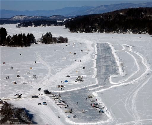 Planes are parked after flying in on frozen Lake Winnipesaukee Saturday, Feb. 28, 2015, in Alton,N.H. Dozens of pilots flew in to the the only ice runway in the Lower 48 states approved by the Federal Aviation Administration. (AP Photo/Jim Cole)