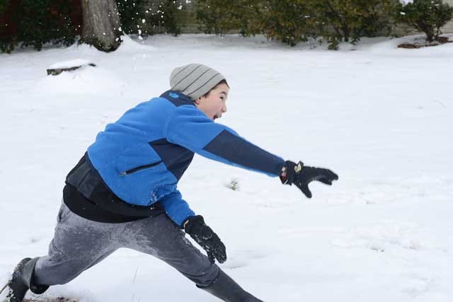 Luke Cannon, 10, throws a snowball Wednesday after several inches of snow fell from the previous night’s winter storm.