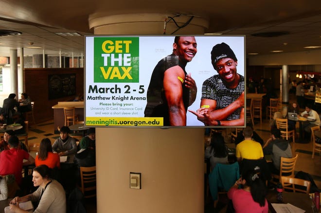 A public service announcement encouraging students to get a vaccination plays on a screen in the Erb Memorial Union on campus. (Chris Pietsch/The Register-Guard)