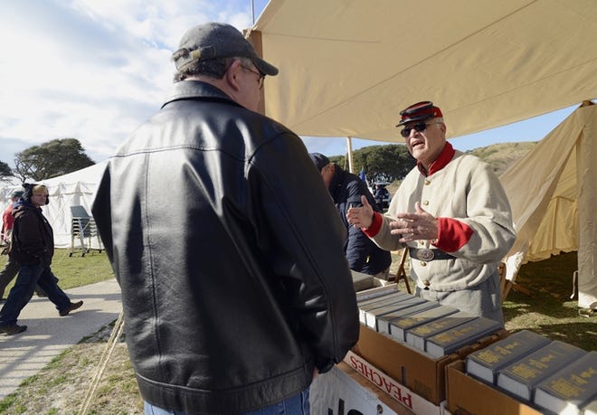 Glenn Kye of the Sons of Confederate Veterans N.C. Division discusses Civil War history at a re-enactment at Fort Fisher in 2013.