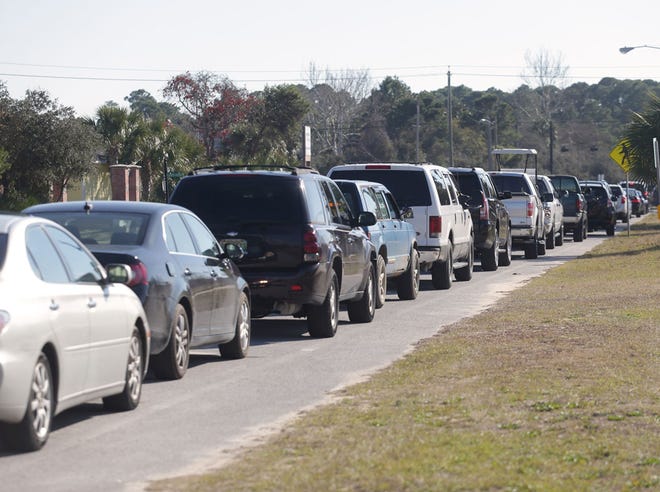 A long line of cars stretches down Clara Avenue as parents wait to pick up students from Hutchison Beach Elementary in January.