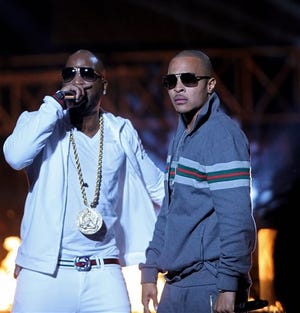 File-This Oct. 1, 2011, fi;e photo shows Rapper T.I., right, and Young Jeezy, left, performing during the BET Hip Hop Awards in Atlanta. Two people suffered non-life-threatening injuries after being shot Saturday, Feb. 28, 2015, at a Charlotte nightclub where rappers T.I., Young Jeezy and Yo Gotti were advertised to appear, a Charlotte-Mecklenburg police spokesman said. USA Today is reporting all three rappers were on stage during the shooting.(AP Photo/David Goldman, File)
