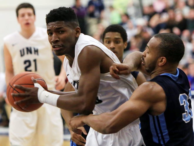 UNH’s Jaleen Smith, left, battles with Maine’s Troy Reid-Knight during Saturday’s game at Lundholm Gym.