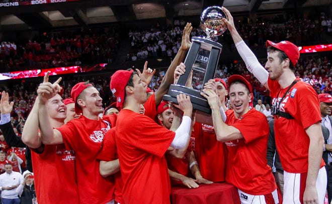 Wisconsin teammates celebrate with the Big Ten trophy after Wisconsin defeated Michigan State 68-61 in an NCAA college basketball game, Sunday, March 1, 2015, in Madison, Wis.