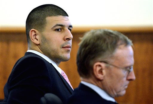 Former New England Patriots NFL football player Aaron Hernandez, left, sits with his attorney Charles Rankin, during his murder trial at Bristol County Superior Court, Friday, Feb. 27, 2015, in Fall River, Mass. Hernandez is charged in the murder of Odin Lloyd in 2013. (AP Photo/The Boston Herald, Ted Fitzgerald, Pool)
