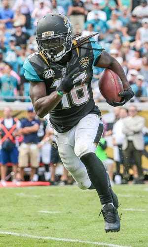 Gary McCullough/For The Times-Union --10/19/14 -- Jaguars' wide receiver Denard Robinson (16) runs the ball scoring a touchdown against the Cleveland Browns during the fourth quarter of NFL football action Sunday. The Jacksonville Jaguars hosted the Cleveland Browns at EverBank Field in Jacksonville, Fla., Sunday, October 19, 2014. (The Florida Times-Union, Gary McCullough)