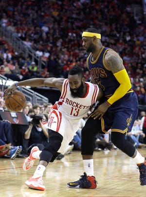 Houston Rockets' James Harden (13) pushes against Cleveland Cavaliers' LeBron James (23) in the second half of an NBA basketball game Sunday, March 1, 2015, in Houston. The Rockets won 105-103 in overtime. (AP Photo/Pat Sullivan)