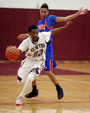 New Jersey Herald photo by Marie Dirle/Newton's Samir Wheeler (23) tries to push the ball upcourt past a towering Lodi defender during the first half of Monday's North 1, Group 2 first-round game at Newton High School.i