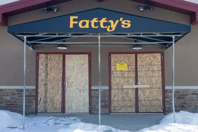 Boards cover the doors and windows at Fatty McGee's on Monday, March 2, 2015, in Rockford. MAX GERSH/RRSTAR.COM