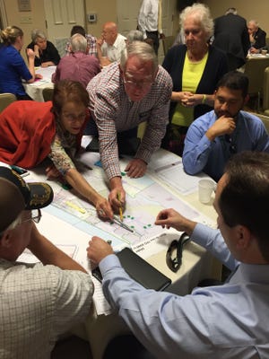 Flagler Beach Commissioner Jane Mealy, left, points to a map during a transportation workshop in Palm Coast.