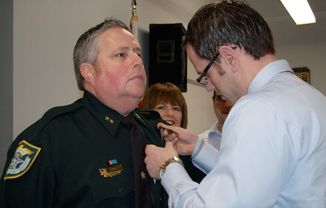 Robert Jones was promoted to Volusia County Sheriff’s Office’s chief deputy Tuesday. On of two stars is pinned on him during a ceremony.