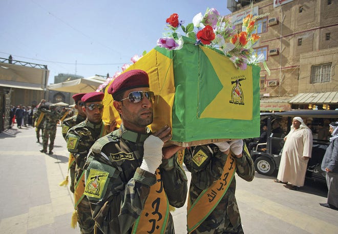 Jaber al-Helo/Associated Press Iraqi Hezbollah fighters carry the coffin of their comrade Ali Mansour, who his family said was killed in Tikrit fighting Islamic State militants, during a funeral procession Monday in the Shiite holy city of Najaf.