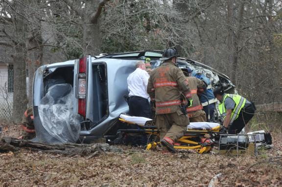 Emergency personnel work to remove the victim of a single-car crash on South Lafayette Street in Shelby on Tuesday afternoon. The woman, whose name was not released as of Tuesday night, was pronounced dead at the scene.