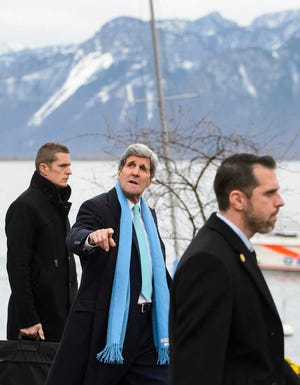 U.S. Secretary of State John Kerry, centre, backdropped by a mountain range as he walks prior to a bilateral meeting with Iranian Foreign Minister Mohammad Javad Zarif for a new round of Nuclear Talks, in Montreux, Switzerland, Monday, March 2, 2015. (AP Photo/Keystone, Jean-Christophe Bott)