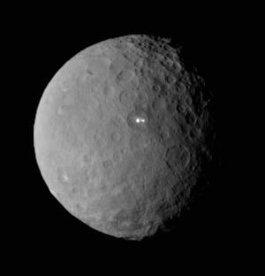 This Feb. 19, 2015 image shows the swarf planet Ceres provided by NASA, taken by the agency's Dawn spacecraft from a distance of nearly 29,000 miles (46,000 kilometers). It shows that the brightest spot on Ceres has a dimmer companion, which apparently lies in the same basin, seen at center of the image. Dawn is preparing to rendezvous with the largest object in the asteroid belt located between Mars and Jupiter, scheduled to go into orbit Friday, March 7 after a three-year journey. Dawn is about 590 miles (950 kilometers) in diameter. (AP Photo/NASA/JPL-Caltech/UCLA/MPS/DLR/IDA)