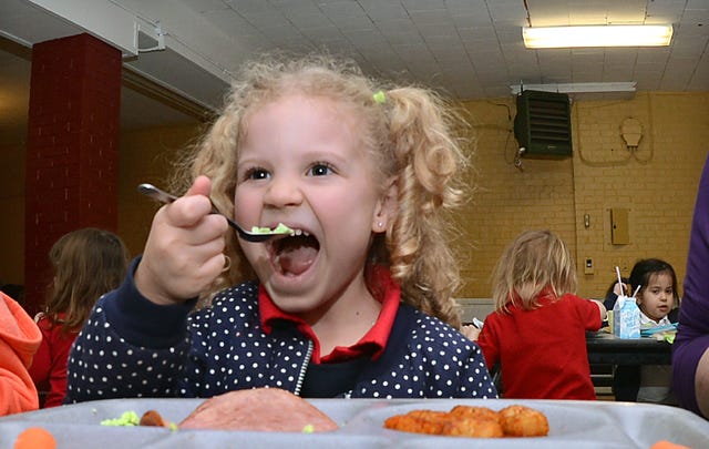 BRIAN D. SANDERFORD • TIMES RECORD
St. Boniface pre-K student Amelia Boyd, 4, tries green eggs during a Green Eggs and Ham lunch at the school on Monday. Volunteer Janie Weber read Dr. Seuss' "The Cat in The Hat" to the students during the lunch as the school celebrated writer illustrator Theodor Seuss Geisel's (March 2, 1904 - Sept 24, 1991) birthday. Amelia is the daughter of Justin and Lori Boyd. 
 BRIAN D. SANDERFORD • TIMES RECORD 
Volunteer Janie Weber reads Dr. Seuss' "The Cat in The Hat" to St. Boniface students during a Green Eggs and Ham lunch at the school on Monday, March 2, 2015. The school was celebrating writer illustrator Theodor Seuss Geisel's (March 2, 1904 - Sept 24, 1991) birthday. The National Education Association has adopted March 2 as Read Across America Day.