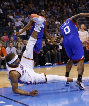 Thunder guard Russell Westbrook falls to the floor after tumbling over 76ers guard Isaiah Canaan during Wednesday's game in Oklahoma City.