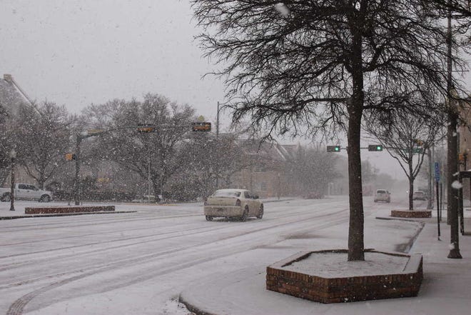 Snow blows down Broadway early in the afternoon Wednesday in Lubbock.