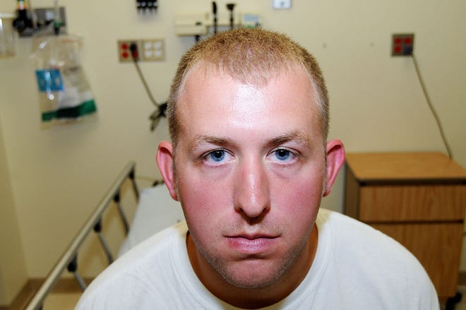 This 2014 file photo shows Ferguson police officer Darren Wilson during his medical examination after he fatally shot Michael Brown, in Ferguson, Mo.