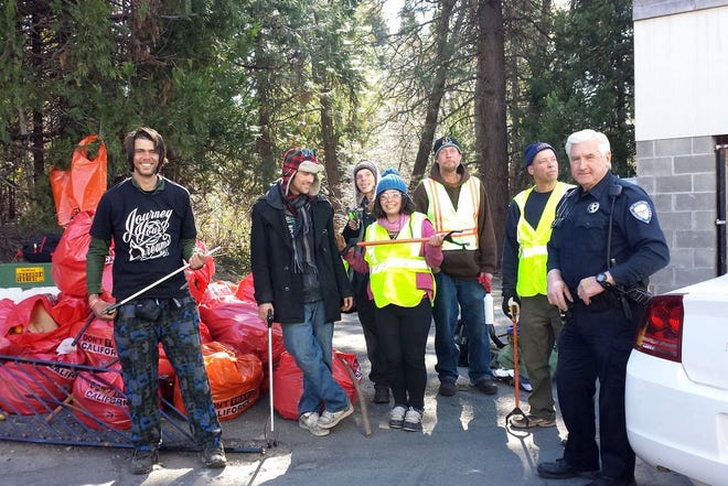 Members of a volunteer clean-up crew take a break from clearing trash behind the shopping center on Lake Street in Mount Shasta. The project was conceived and implemented by MSPD officer Frank Goulart, right. Crew members, left to right, Joe Mosh, Dylan Spicer, Jarod Hartlerode, McKenna Beckstrand, Scott Roberts, and William Riley.