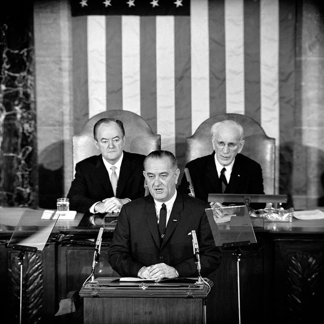 FILE - In this March 15, 1965 file photo, U.S. President Lyndon B. Johnson addresses a joint session of Congress in Washington where he urged the passing of the Voting Rights Act and spoke of his experience as a young teacher in a segregated, Mexican-American school. Vice President Hubert Humphrey is at left and House Speaker John McCormack is at right. (AP Photo/File)