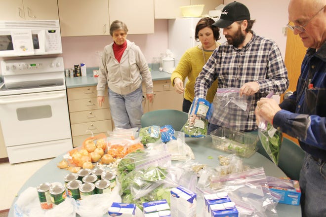 Participants in the Cooking Matters course collect ingredients to make the day's recipe back at home.