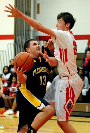 Florence senior Michael Muchowski (13) is defended by James Brett of Palmyra.