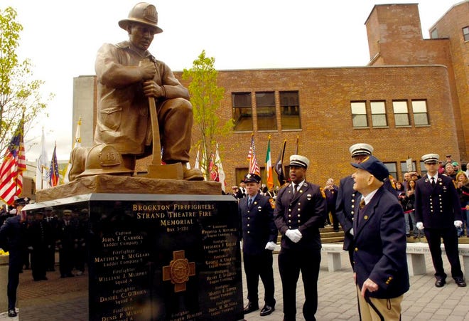 PHOTO TAKEN ON MAY 10, 2008: BROCKTON, MA USA: Brockton retired Fire Chief Edward Burrell, 93, right, looks over the unveilled monument at City Hall Plaza.