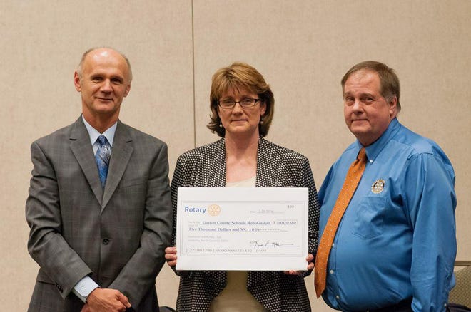 Pictured from left are Bill Cook, assistant superintendent for curriculum and instruction, Gaston County Schools; Carrie Minnich, executive director of elementary instruction; and Karl McKinnon, president of Gastonia East Rotary for 2014-15.