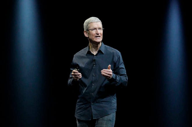 FILE - In this June 2 2014 file photo, Apple CEO Tim Cook speaks at the Apple Worldwide Developers Conference event in San Francisco. Apple will replace AT&T in the Dow Jones industrial average, the managers of the index announced early Friday, March 6, 2015. S&P Dow Jones Indices said the switch will take place after the close of trading on Wednesday, March 18. Apple will start trading as part of the 30-stock Dow at the opening of trading the next day. (AP Photo/Jeff Chiu)