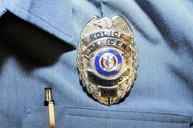 Officer Darren Wilson's police badge is pictured in this handout evidence photo from the Aug. 9 Ferguson Police shooting of Michael Brown in Ferguson, Mo., released by the St. Louis County Prosecutor's Office on Nov. 24. 
REUTERS/St. Louis County Prosecutor's Office/Handout via Reuters