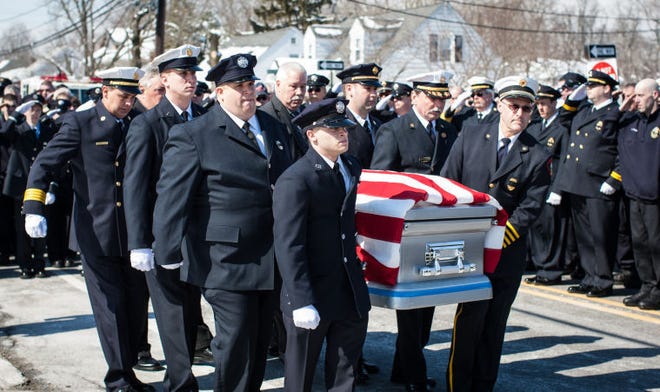 Burlington Township, NJ - Numerous police officers, firefighters and other emergency officials paid their final respects to the late Jim "Libby" Liberatore today at Beverly Road Firehouse in Burlington Township. After the service, Liberatore was be laid to rest in Odd Fellows Cemetery on Route 130. Here Liberatore's casket is carried pass a "wall of blue". Laurence Kelly/Freelance