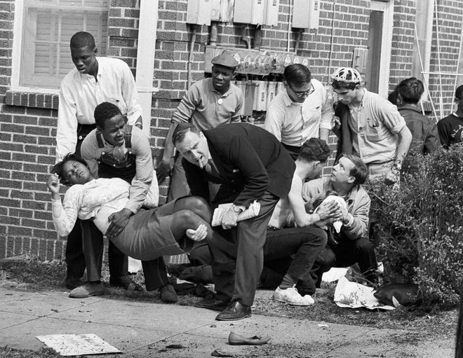 FILE - In this March 7, 1965 file photo, S.W. Boynton is carried and another injured man tended to after they were injured when state police broke up a demonstration march in Selma, Ala. Boynton, wife of a real estate and insurance man, has been a leader in civil rights efforts. The day, which became known as "Bloody Sunday," is widely credited for galvanizing the nation's leaders and ultimately yielded passage of the Voting Rights Act of 1965. (AP Photo/File)