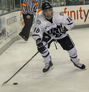 UNH’s Andrew Poturalski looks for an open teammate during Friday night’s game against UCOnn at the Whittemore Center.