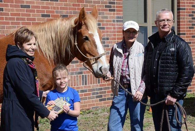 First graders at Horace Mann Elementary took learning outdoors Friday for the Horse Tales literacy event.